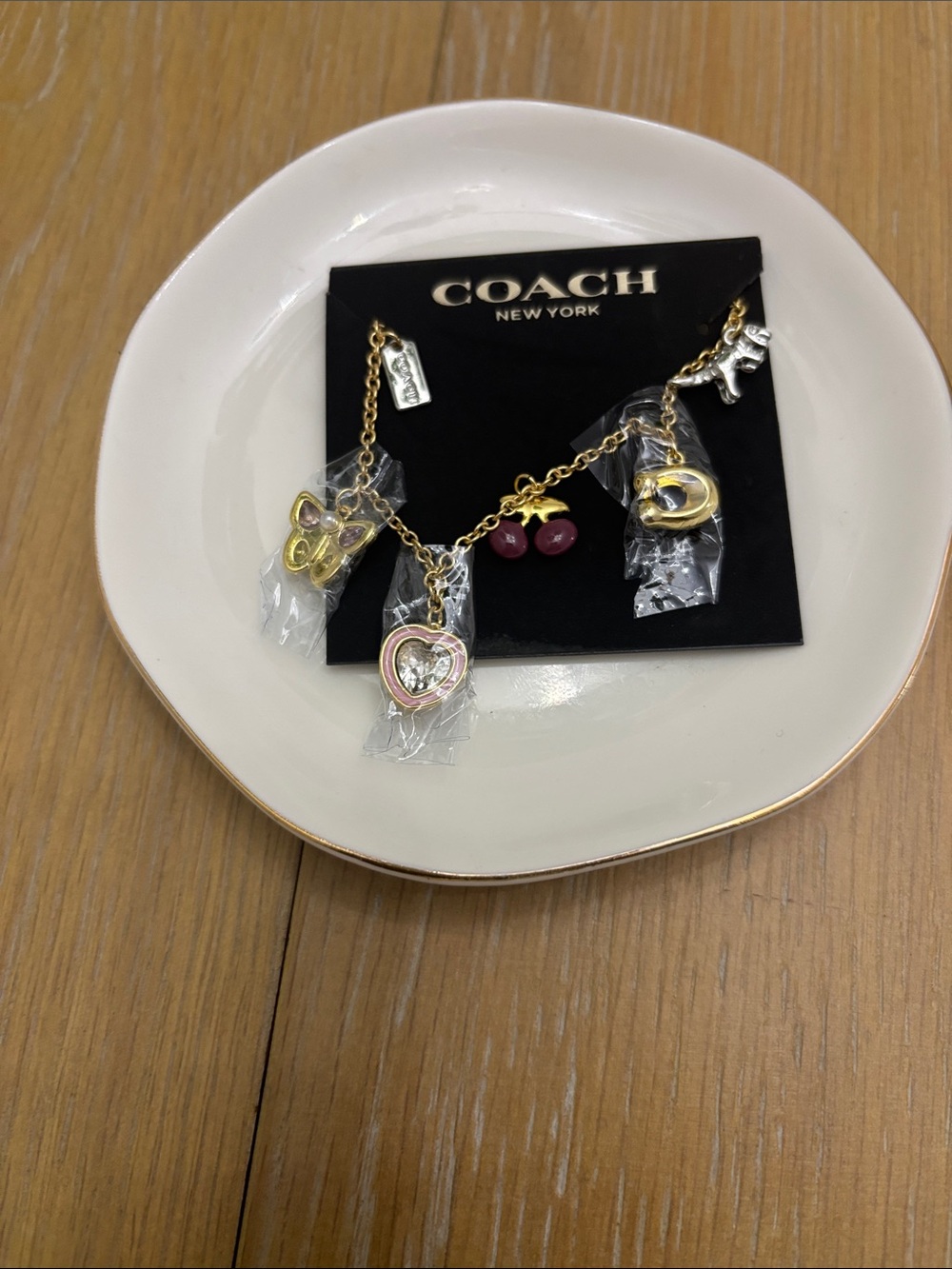 Coach Gold-Tone Charm Bracelet with Pink Heart, Berry & Butterfly Charms